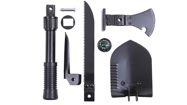 Multi-purpose tool with saw, pickaxe, axe head, shovel, handle, and compass all broken down