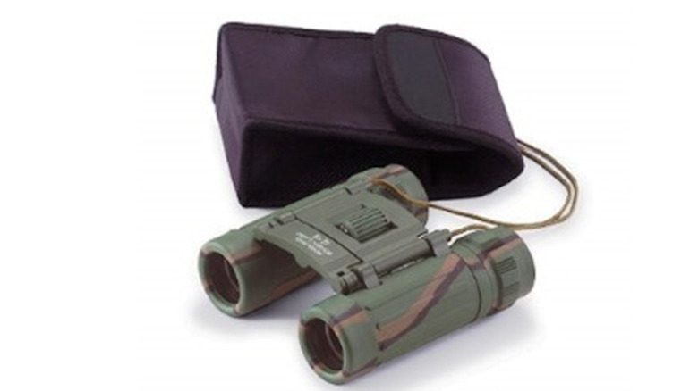 Camouflage binoculars next to a purple nylon case on a white background