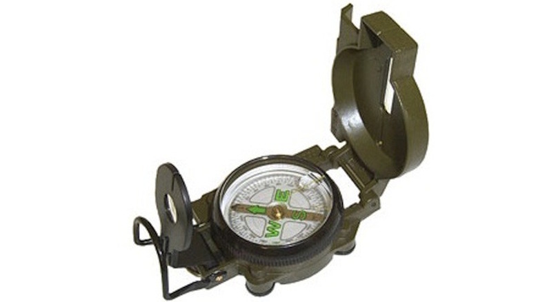 Aluminum cast case around a compass, showing the direction on a white background