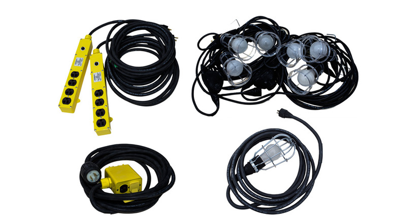 Five piles of lights with black cords and yellow extension cables