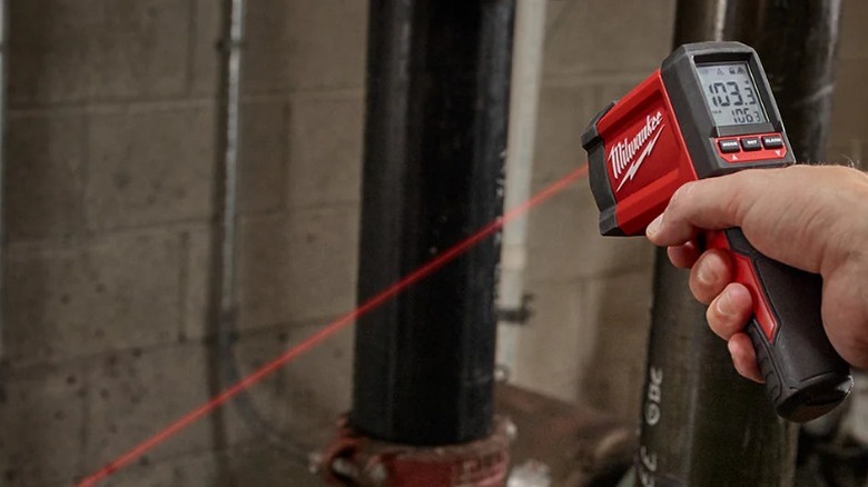 Person using Milwaukee 10:1 Infrared Temp Gun in basement