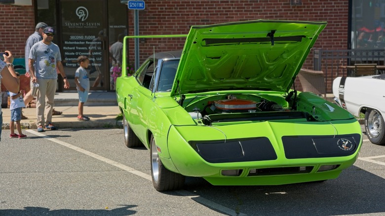 people looking at a classic car
