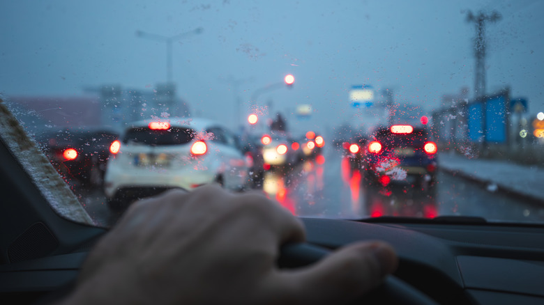 Driving in rainy weather with vehicles stopped