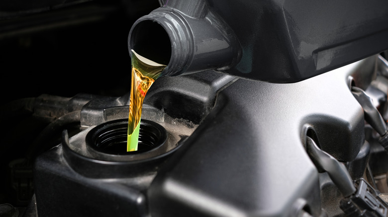 Motor oil being poured into vehicle