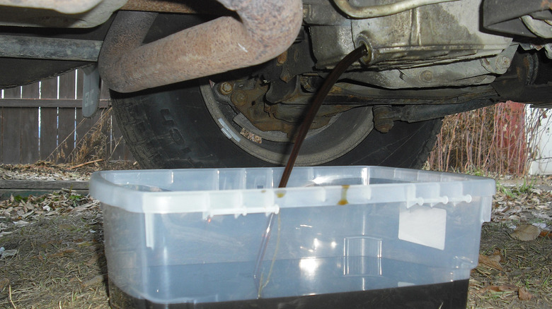 Oil flowing into a container from an engine block