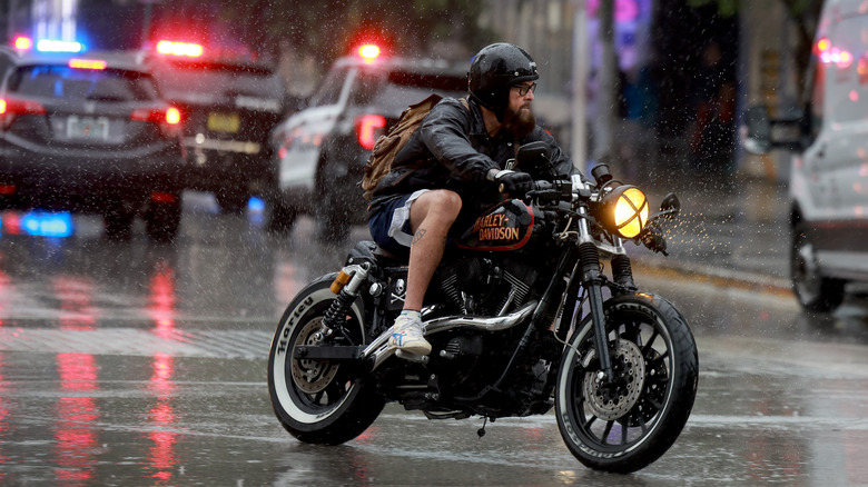 A motorcyclist driving through rain