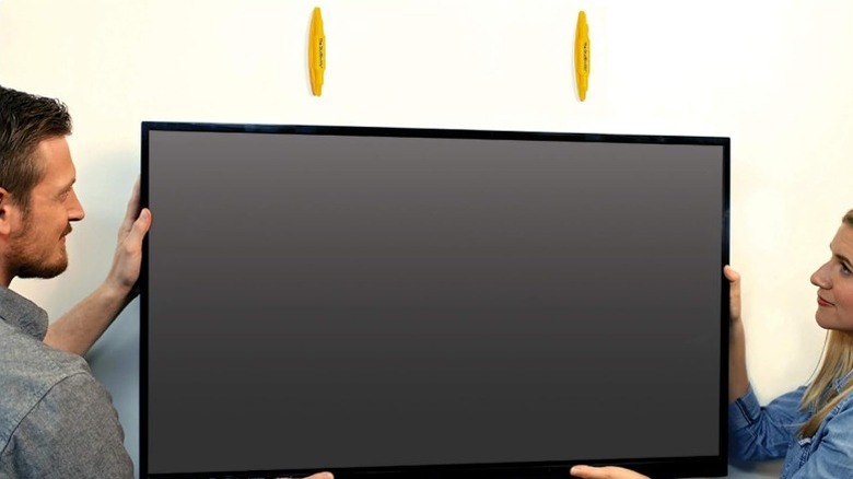 People mounting TV over StudBuddys