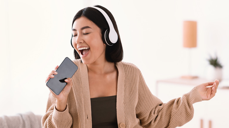 Girl singing karaoke with phone