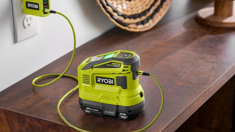 18V One+ 150W Power Source charging battery on a side table