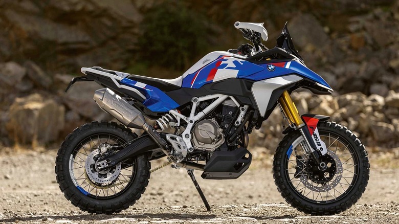 A photo of a rugged BMW F 900 GS concept bike, positioned on rocky terrain.