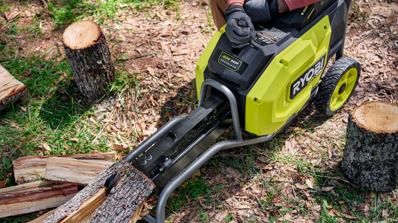 A person using the Ryobi kinetic log splitter