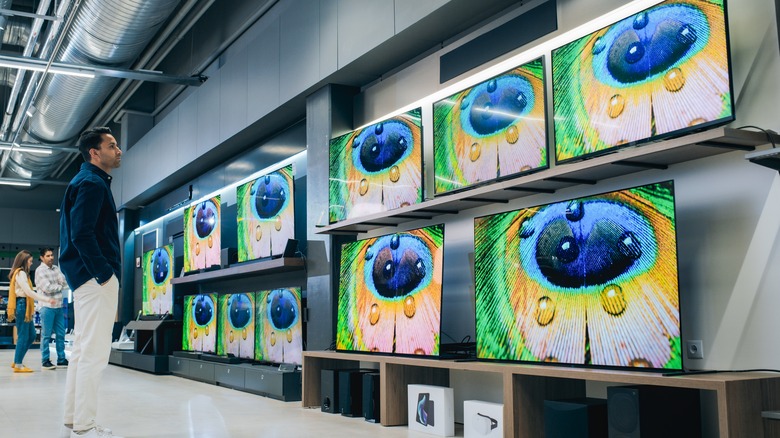 Man looking at TV display