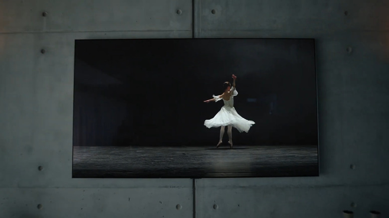 LG 77-inch OLED G4 TV on a wall showing footage of a ballerina