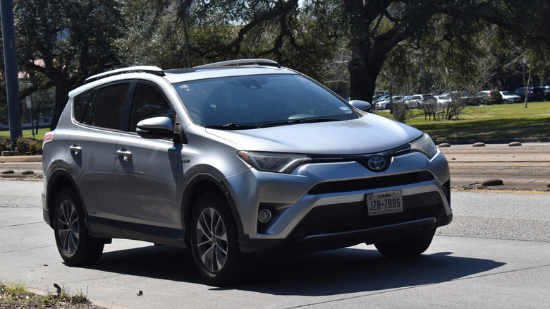 A silver Toyota RAV4 hybrid on a street.