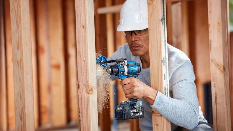 person using hercules drill