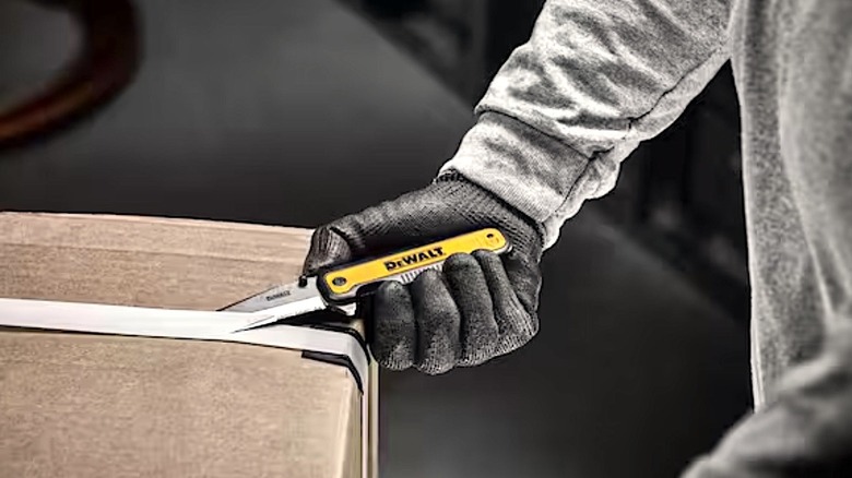 Person using DeWalt knife