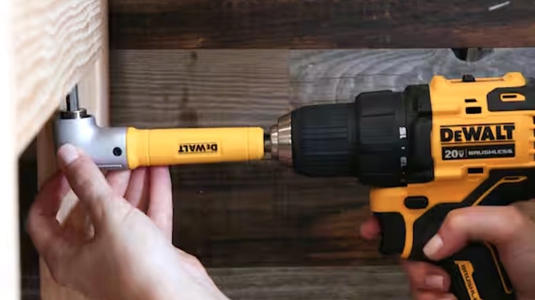 person using right angle drill attachment