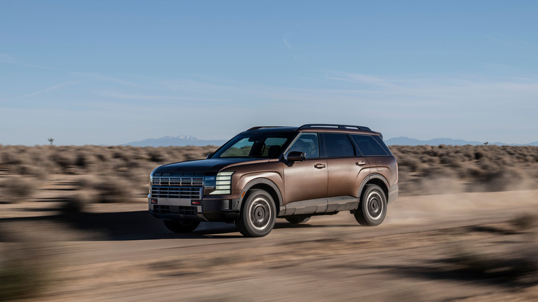 A side on action shot of a 2026 Hyundai Palisade XRT Pro driving