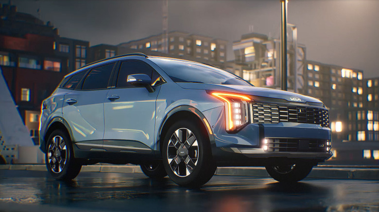 A blue Kia Sportage Hybrid on a wet street