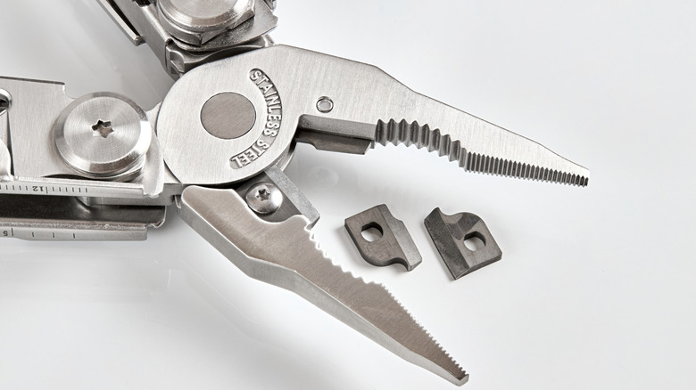 Multi-tool with pliers pulled apart, on white background