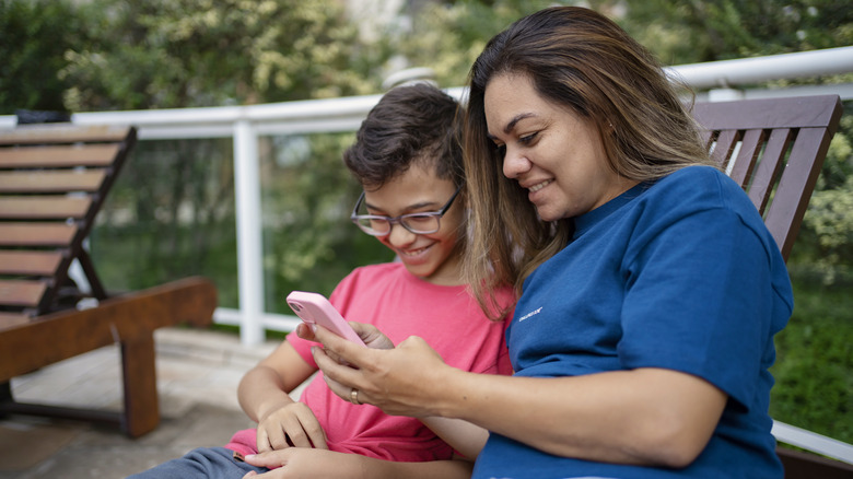 Mother and son using iPhone