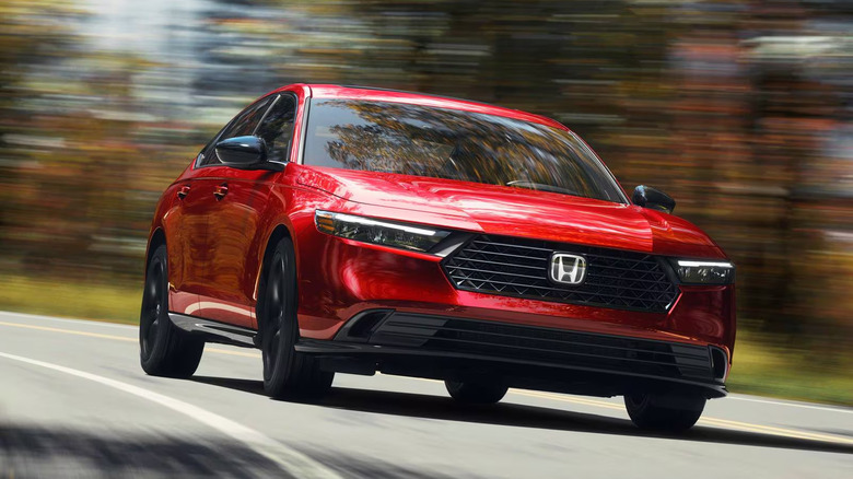A front end shot of a red 2025 Honda Accord driving