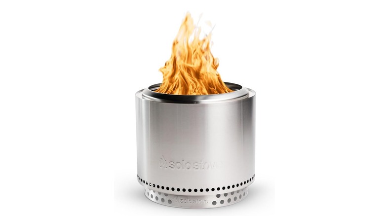 Silver Solo Stove Bonfire with a fire at the top on a white background