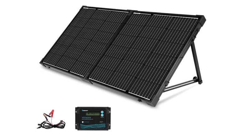 Solar panels slanted on a white background, next to a charge controller and a cable