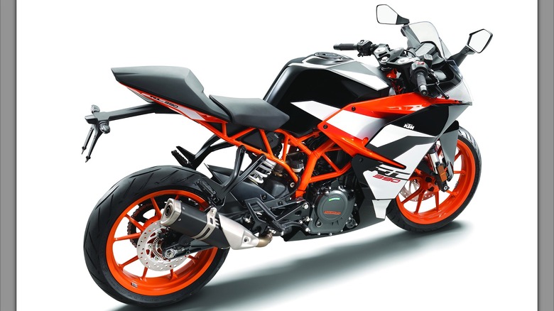 A side-view image of a sharp and track-ready KTM RC390 standing in profile, showing off its bright orange frame and wheels.