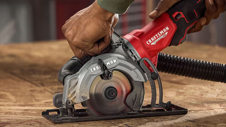 A man cutting plywood with a Craftsman brand circular saw
