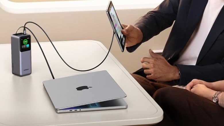 A Ugreen power bank charging a laptop and a tablet