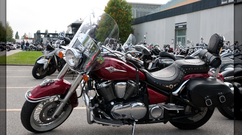 A Kawasaki Vulcan 900 parked at a festival.