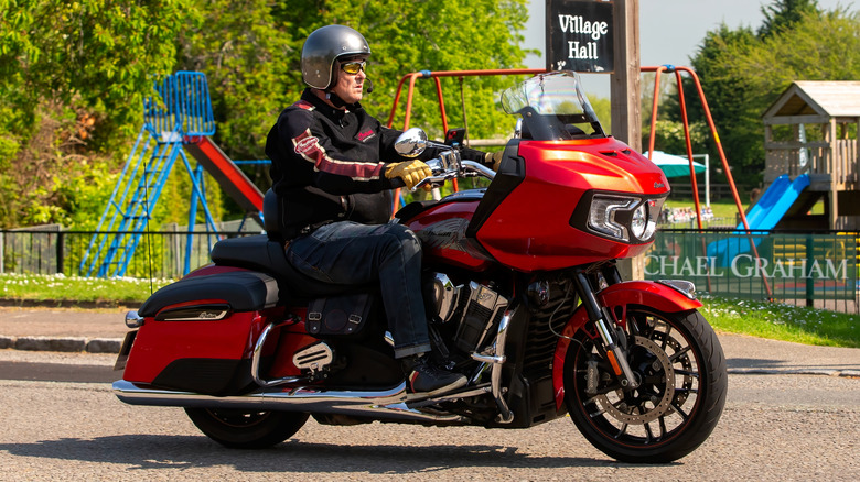 Red Indian Motorcycle Challenger Limited travelling through an English village