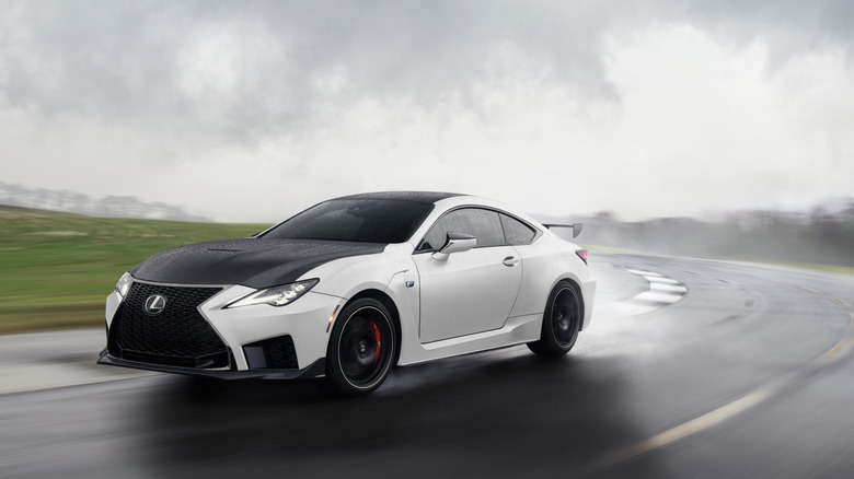 2021 Lexus RC F Fuji Speedway Edition driving on racing circuit in the rain, front-left three-quarter view