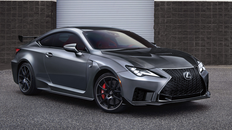 2021 Lexus RC F parked on gravel in front of garage, front-right three-quarter view