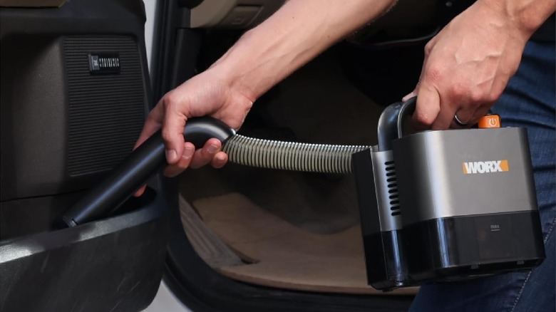 Person holding vacuum cleaner