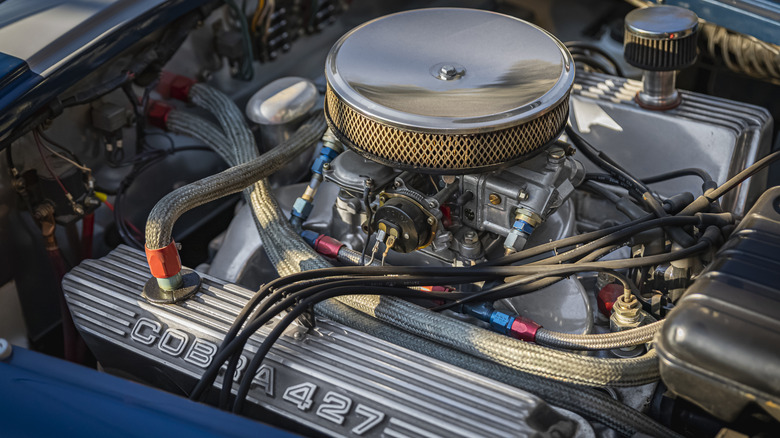 A close-up of a Ford 427 V8 engine in a Shelby Cobra engine bay.