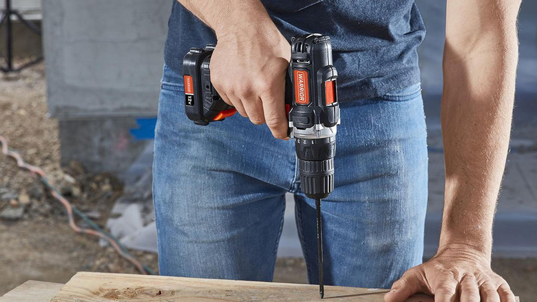 person using warrior cordless drill