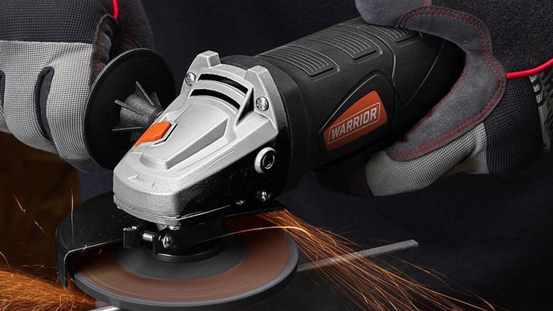 person using warrior angle grinder