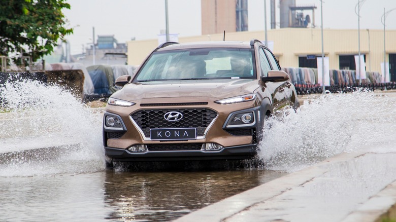 Hyundai Kona car crossing the water road
