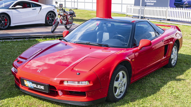 Red Honda NSX front right 3/4 view parked in grass