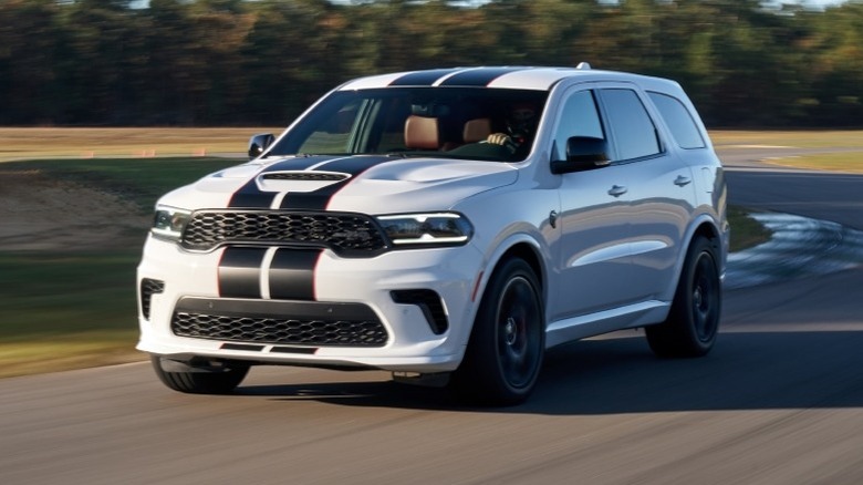 2021 Dodge Durango SRT driving around a turn with trees in the background