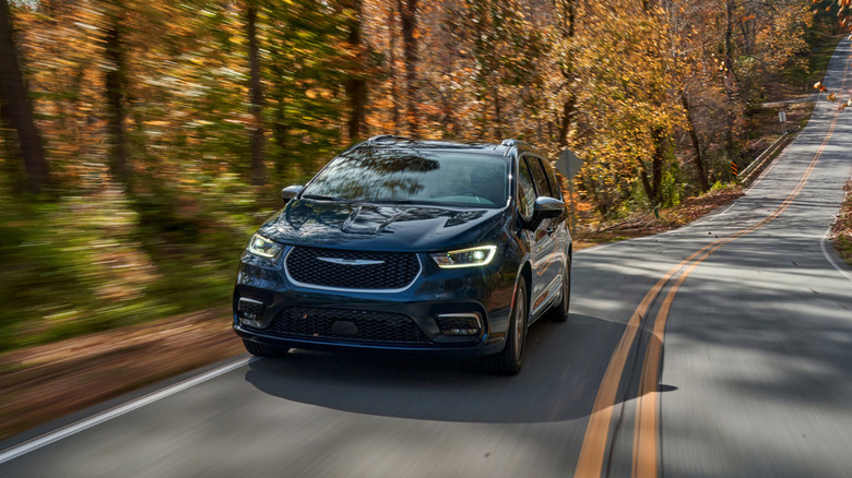 Front view of Chrysler Pacifica Hybrid minivan driving on road