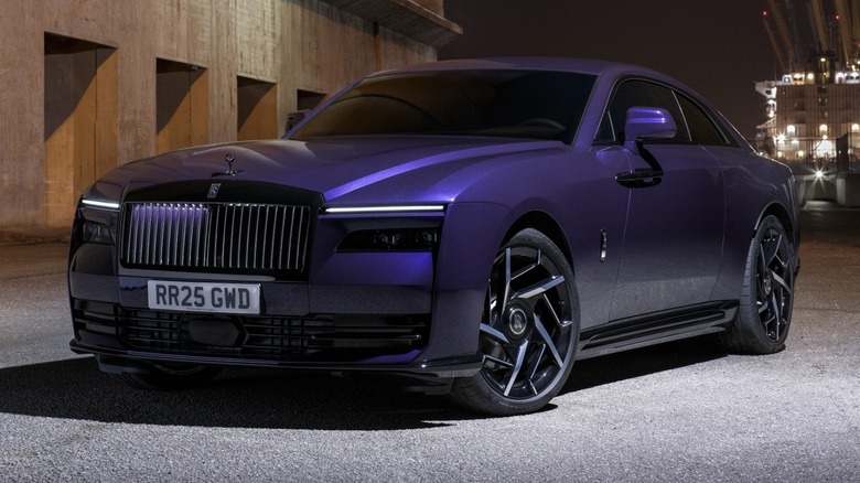Rolls-Royce Black Badge Spectre parked front of a building at night