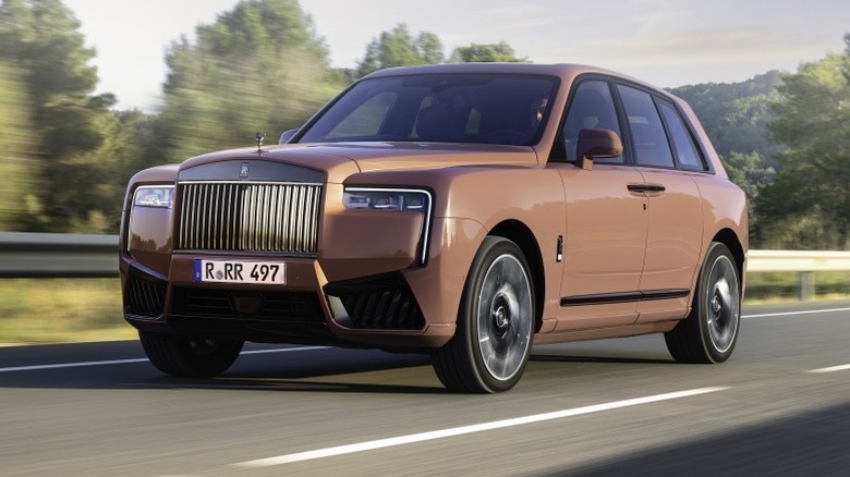 Front 3/4 action view of a Rolls-Royce Cullinan Black Badge Series II