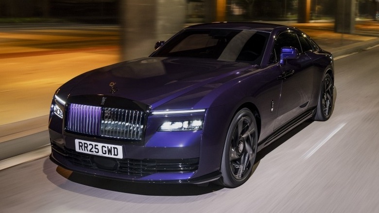 Rolls-Royce Black Badge Spectre driving on a road at night