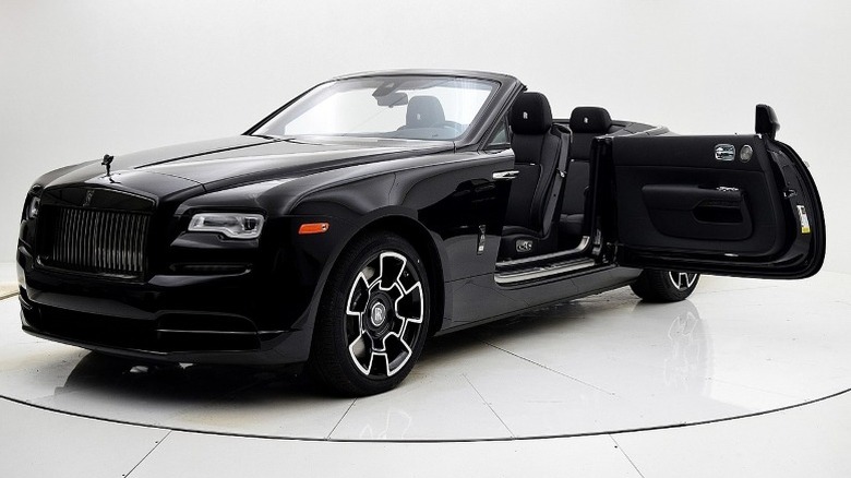 Front 3/4 view of a Rolls-Royce Dawn Black Badge convertible with its driver's side door opened