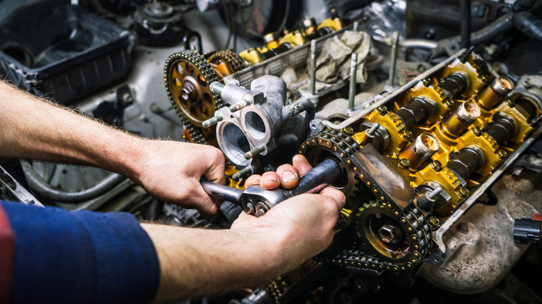 Mechanic works on V6 engine