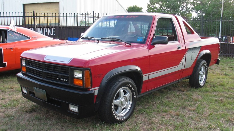 Red 1989 Dodge Dakota Shelby parked next to General Lee orange Dodge Charger
