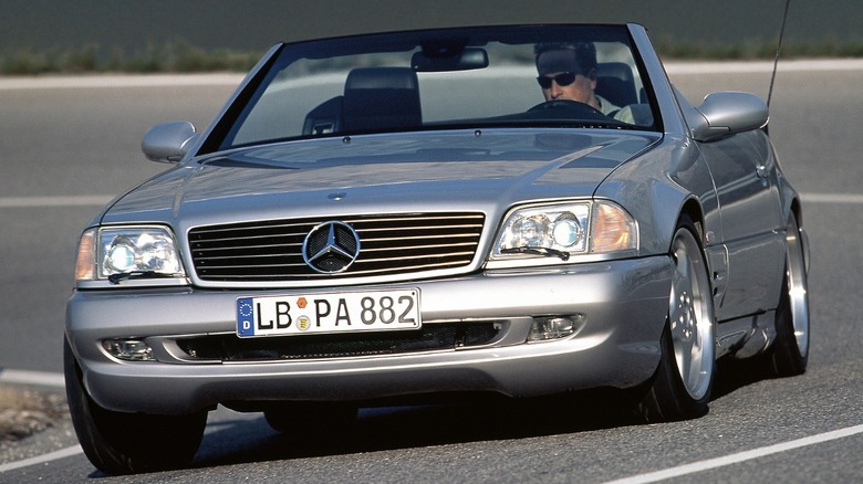 Mercedes-Benz SL 73 AMG driving on road with convertible top down, front-left three-quarter view